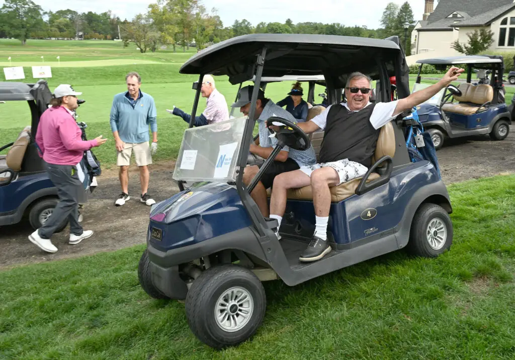 Golfer in golf cart at start of MPCF golf outing